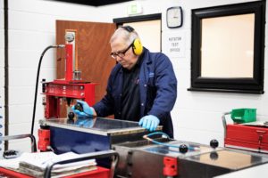 Helical Technology employee running a test in the new Valve Rotator Test Facility